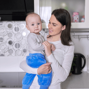 Mother holding her toddler closely while wondering how many words should an 18 month old say