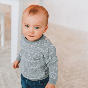 Toddler standing with interest, prompting thoughts on how many words should an 18 month old say