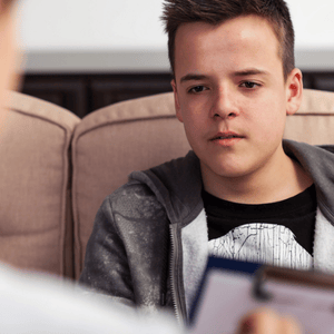 A boy listens during a puberphonia treatment session designed to improve his vocal pitch