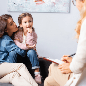 Parent and child attend therapy consultation to discuss treatment plan for childhood dysarthria symptoms