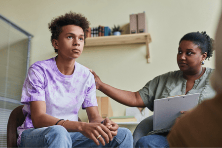 A teenage boy receives puberphonia treatment through guided therapy from a certified speech pathologist