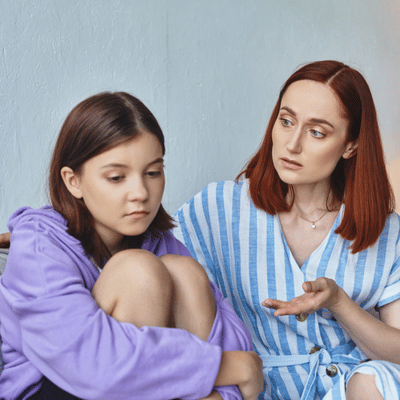 Adult talks with upset teen during motivational speech for teenager about handling stress and conflict