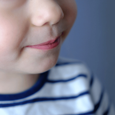 Close-up of child’s mouth forming sounds, useful for speech therapist for 2-year-old evaluation and progress